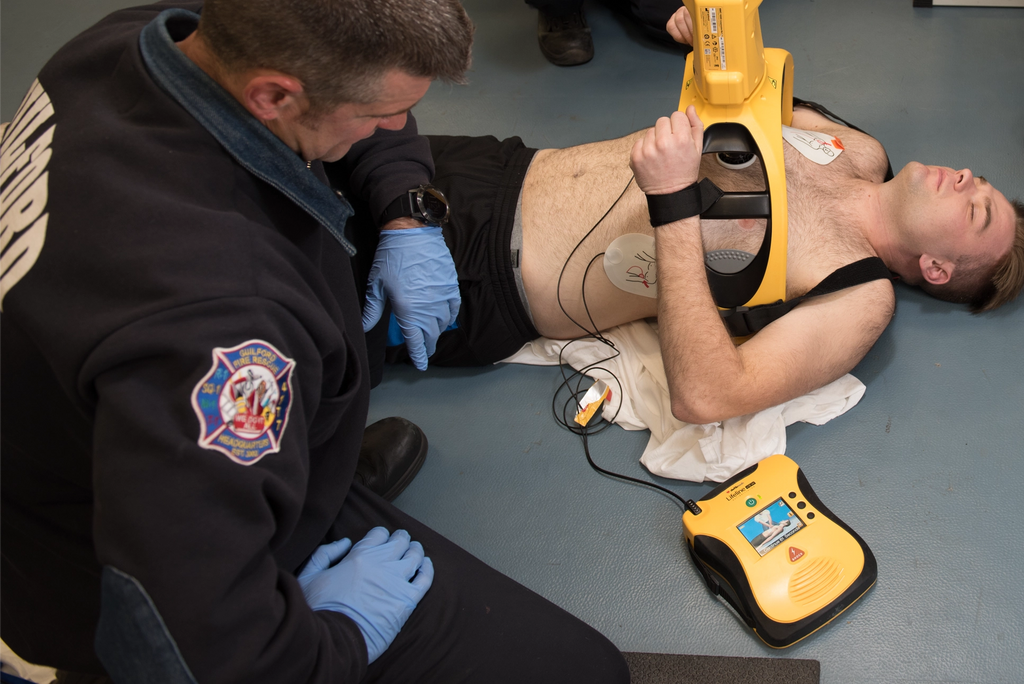 Man receiving CPR chest compressions from machine