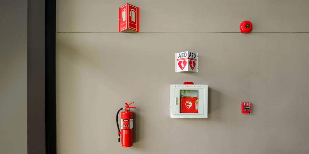 A portable defibrillator cabinet with a fire extinguisher