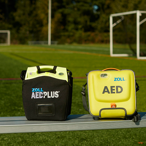 green zoll aeds on a bench at a soccer field