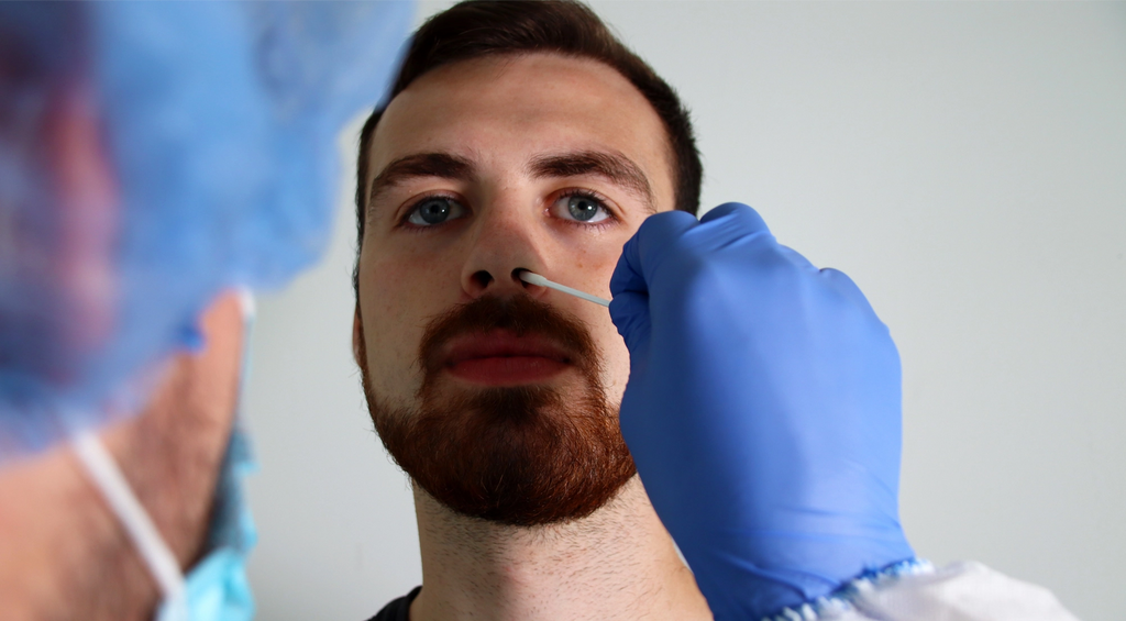 Man getting his nose swabbed to test for antigens