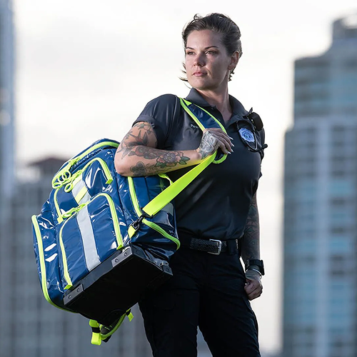 woman in a paramedic uniform holding a statpacks ems jump bag